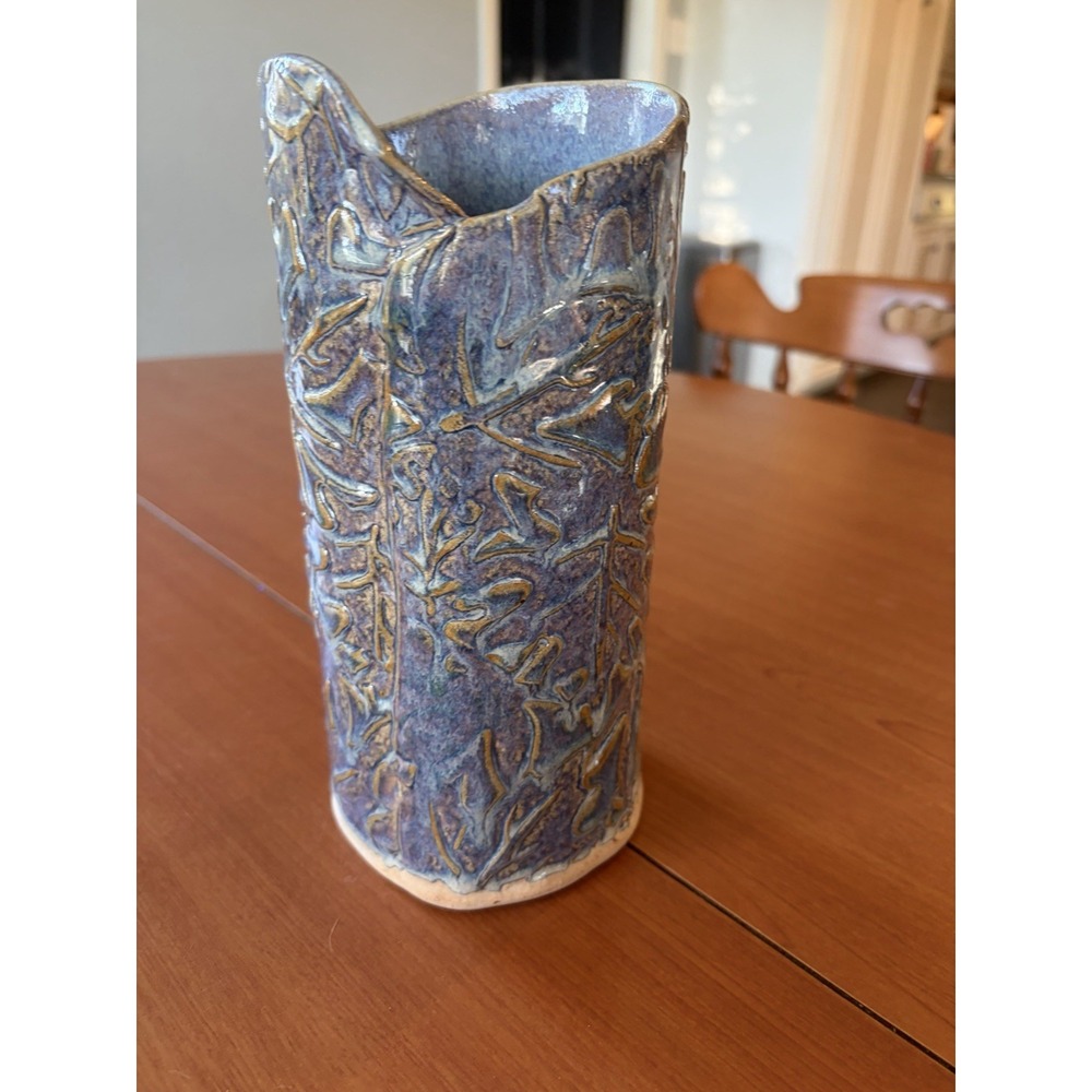 Hand crafted pottery vase in blues and browns with an incised Backstamp